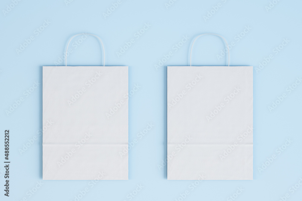 Close up of empty white paper bag on blue wallpaper. Shopping concept. Mock up, 3D Rendering. Close up of empty white paper bag on blue wallpaper. Shopping concept. Mock up, 3D Rendering.