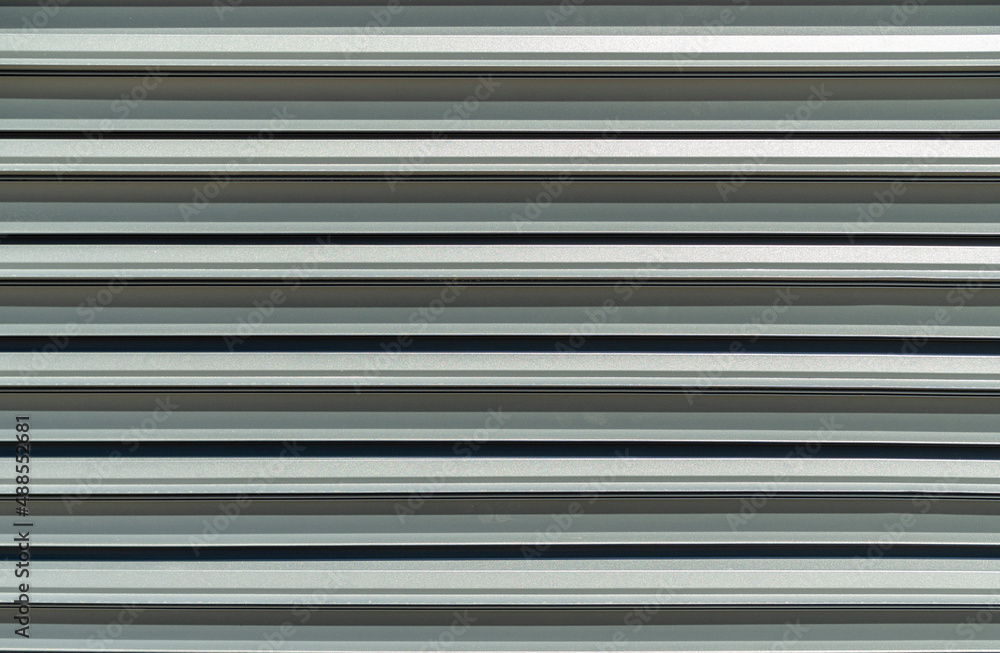 Modern metal fence blinds with shutters texture. Front view metal fence background Modern metal fence blinds with shutters texture. Front view metal fence background