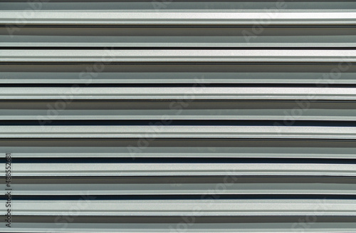 Modern metal fence blinds with shutters texture. Front view metal fence background