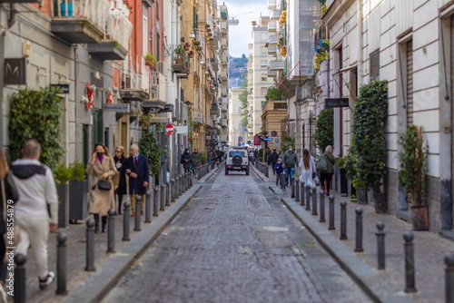 narrow European city road with a car driving away