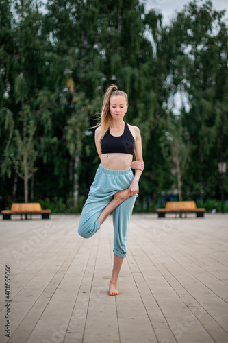Girl practice yoga and meditation in the city. © grthirteen