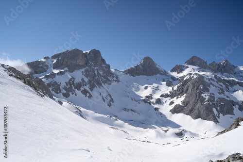 snowy peaks in the mountains in winter in Picos de Europa National Park © urdialex