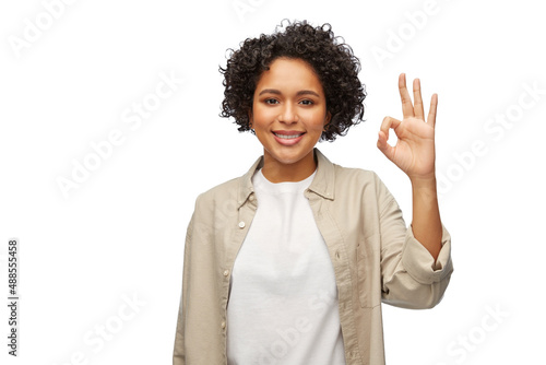 people, gesture and portrait concept - happy smiling woman in shirt showing ok hand sign over white background © Syda Productions