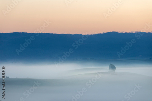 Tuscany landscape at sunrise with fog