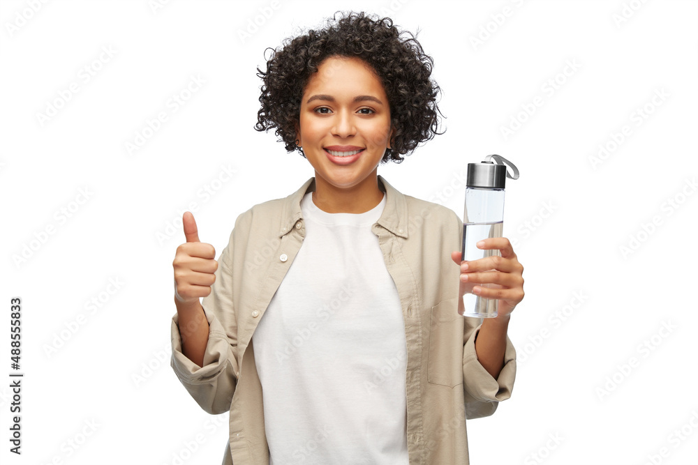 eco living, zero waste and sustainability people concept - happy smiling woman with drinking water in glass bottle showing thumbs up over white background eco living, zero waste and sustainability people concept - happy smiling woman with drinking water in glass bottle showing thumbs up over white background