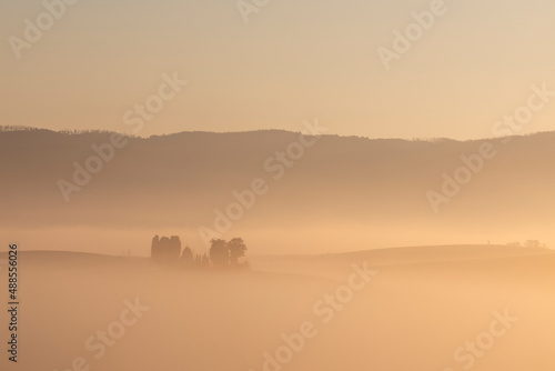 Tuscany landscape at sunrise with fog