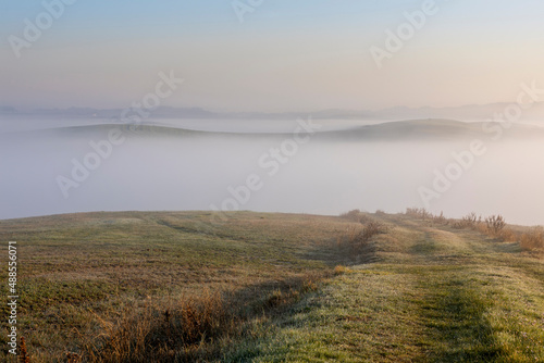 Tuscany landscape at sunrise with fog