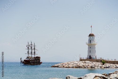 Wallpaper Mural Alanya, Turkey - Sea pier port with lighthouse in marina with a ship sailing in the sea. Sea coast Torontodigital.ca