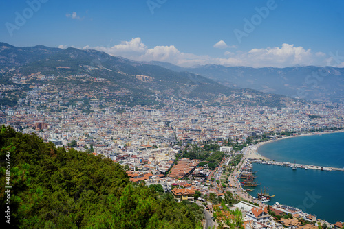 Alanya, Turkey - Day view on historical harbor of Alanya, the seashore and mountains with many houses on the coast