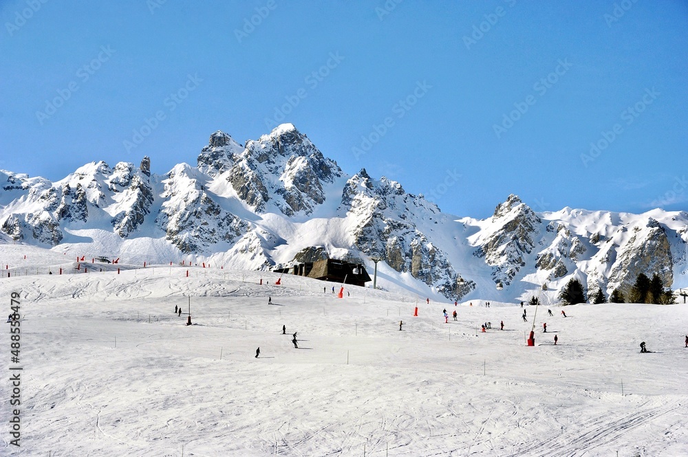 Snowcapped mountain with skiers in winter 