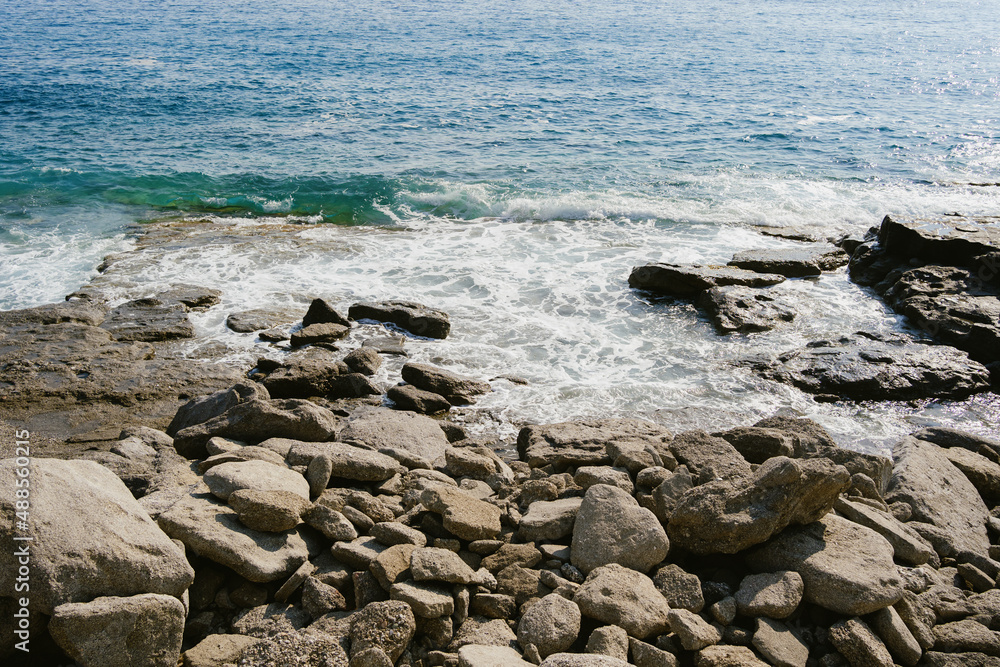 View on blue seawater meeting rocky shore View on blue seawater meeting rocky shore