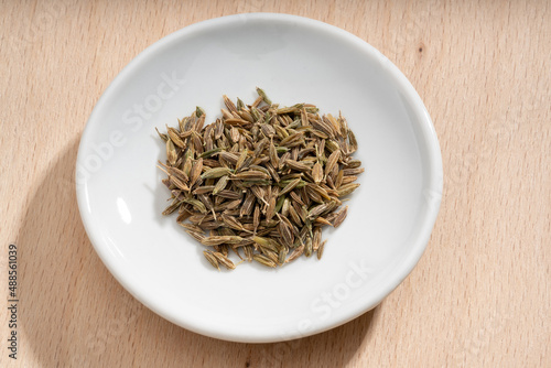 Detailed and large close up shot of cumin on a small plate