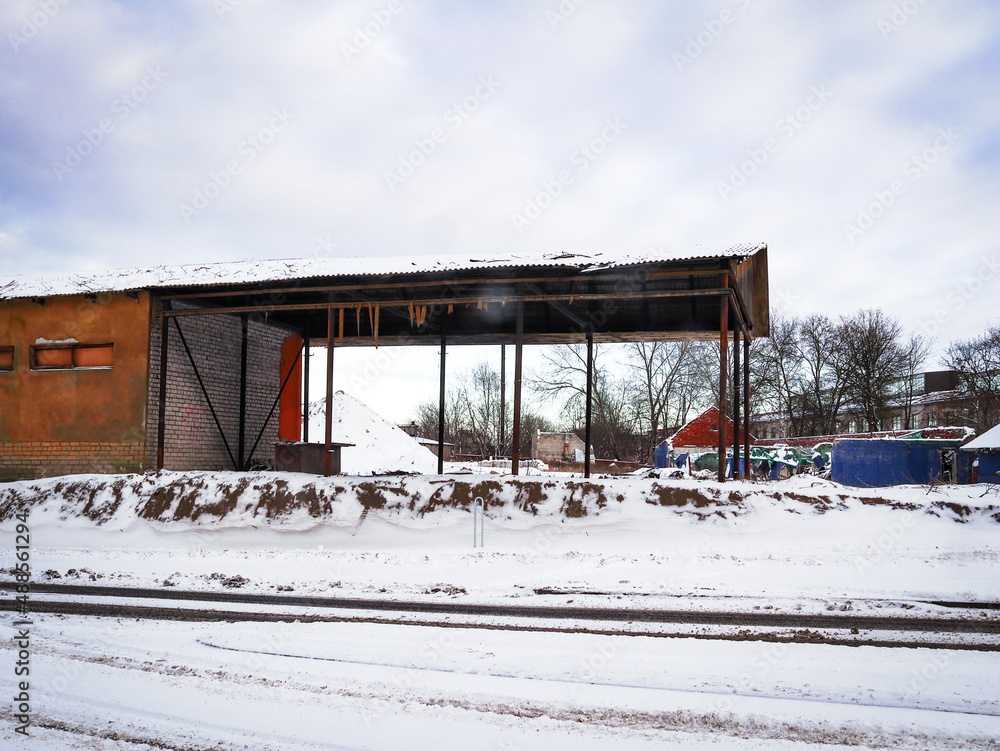 Old abandoned open storage house in winter on blue sky background with couds Old abandoned open storage house in winter on blue sky background with couds