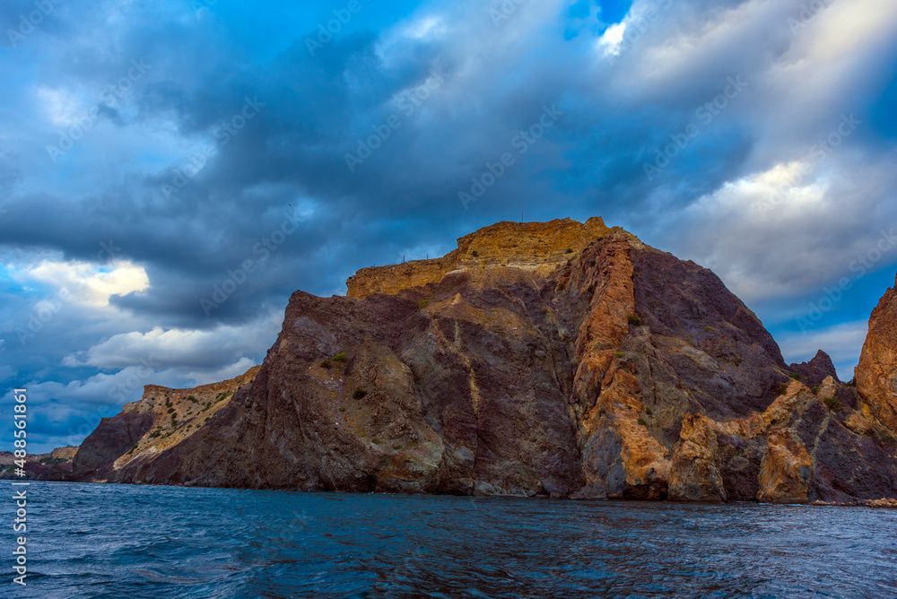 rocks of Cape Fiolent against the background of the evening sky with clouds