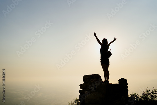 Woman successful hiking climbing silhouette in mountains, motivation and inspiration in beautiful sunset