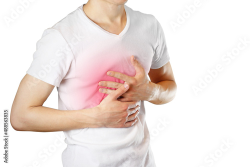 A man holds the Breasts. The pain in his chest. Heartburn. Stomach hurts. Sore point highlighted in red. Closeup. Isolated on white background photo