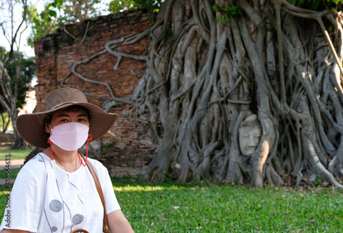Asian women travel to ancient sites during summer vacation.
