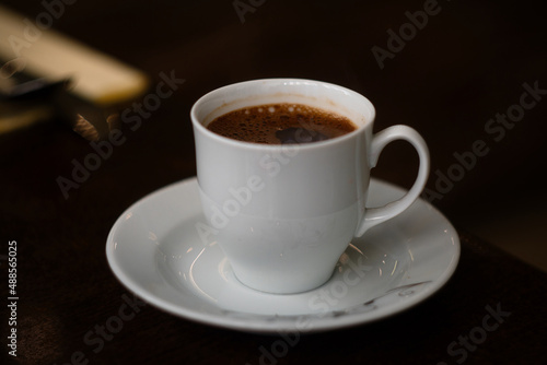Porcelain cup of strong morning black coffee in Arabian style