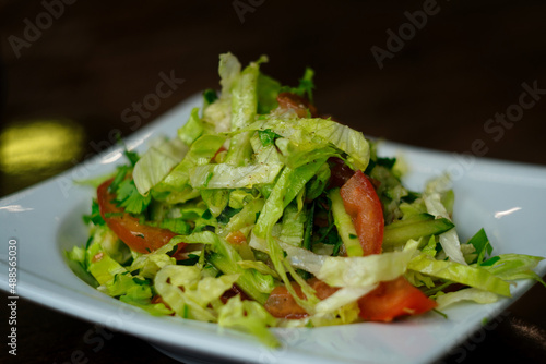 Mixed vegetable salad with coleslaw, arugula, iceberg and herbs