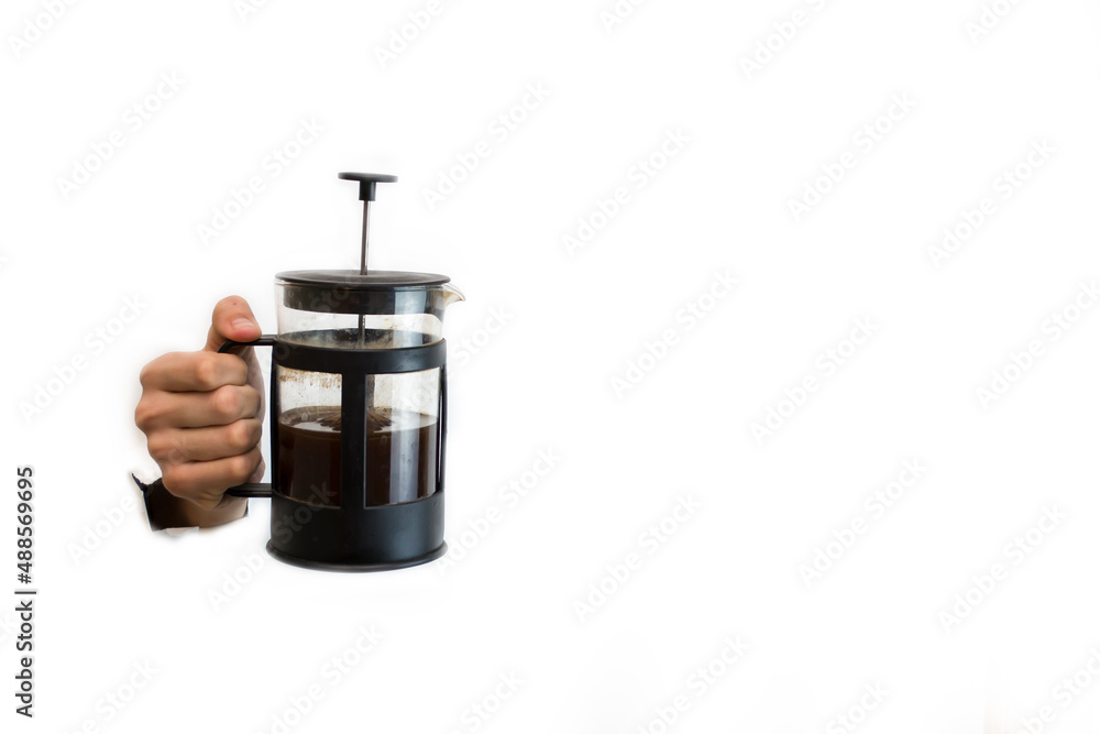 Hand holding black french press with tea on white background Hand holding black french press with tea on white background
