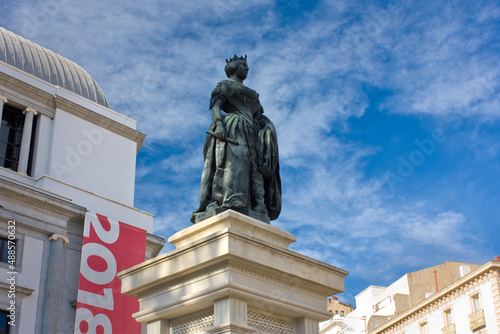 Statue to Queen Isabel II at Opera Square in Madrid photo