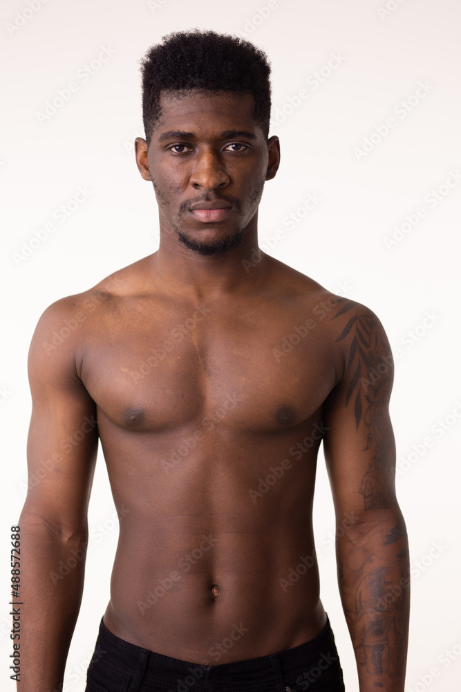 African American bodybuilder man naked muscular torso wearing training pants isolated on white background