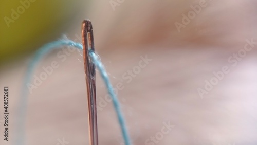 close up of a needle The thread is tucked inside the needle close up hand sewing needle Hole