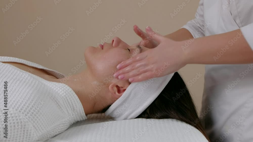 Beautiful woman having massage therapy of face in spa salon. Face Care concept. Beautiful woman having massage therapy of face in spa salon. Face Care concept.