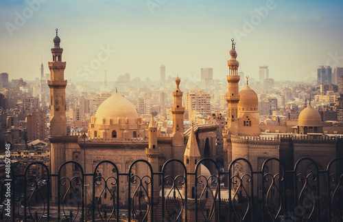 Mosque of Al Rifai and Madrasa of Sultan Hassan in the  Cairo old city. Cityscape scene with ancient muslim architecture with minarets at sunset. photo