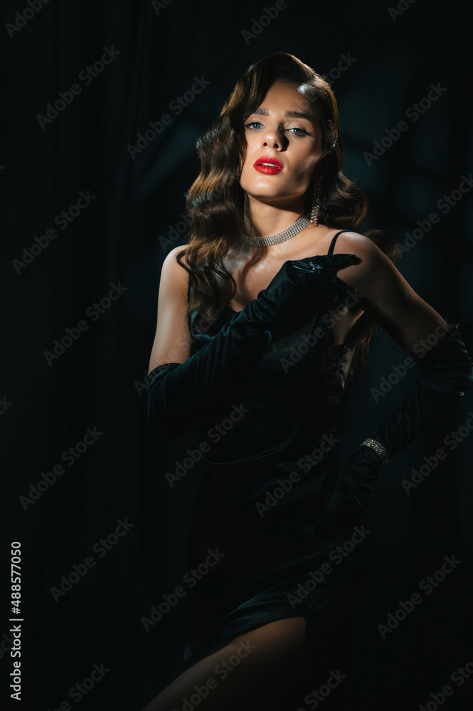 Portrait of beautiful woman in classic retro look. Brunette girl in vintage Hollywood movie style with makeup, hairstyle and jewelry Portrait of beautiful woman in classic retro look. Brunette girl in vintage Hollywood movie style with makeup, hairstyle and jewelry
