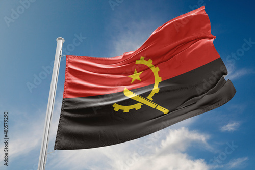 Angola Flag is Waving Against Blue Sky photo