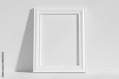 Vertical rectangular photo frame on floor leaning at wall