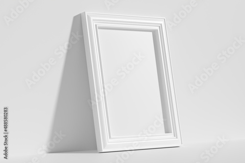 Rectangular photo frame on floor leaning at wall diagonal view
