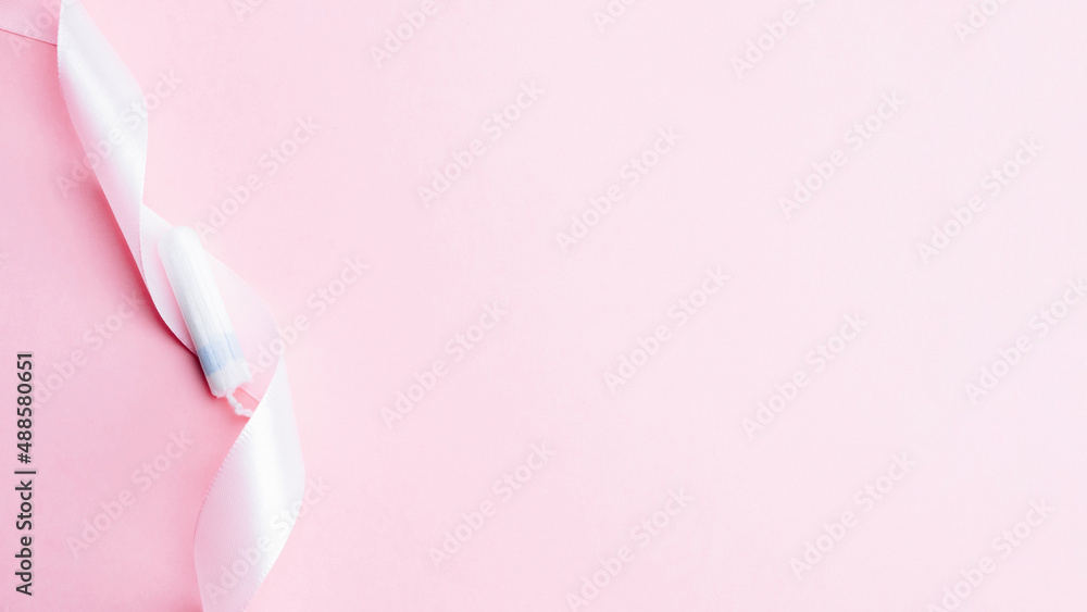 Tampon woman feminine hygiene. Pink ribbon with menstrual tampon on pink background. Menstruation feminine period. Soft tender protection for women critical days. Tampon woman feminine hygiene. Pink ribbon with menstrual tampon on pink background. Menstruation feminine period. Soft tender protection for women critical days.