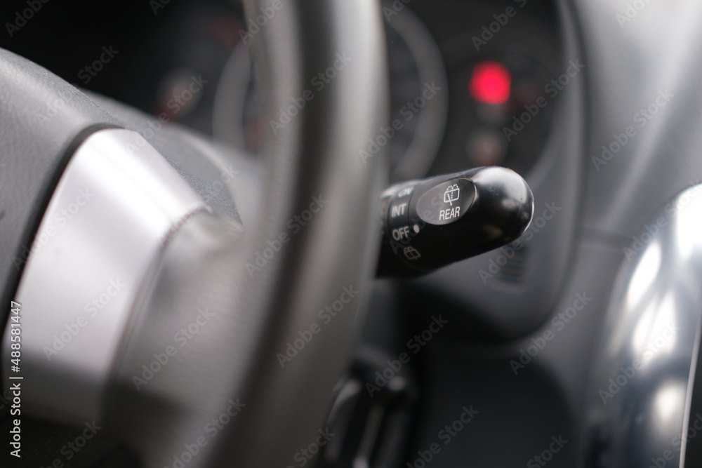 Car interior inside, view of the levers, steering wheel and dashboard closeup