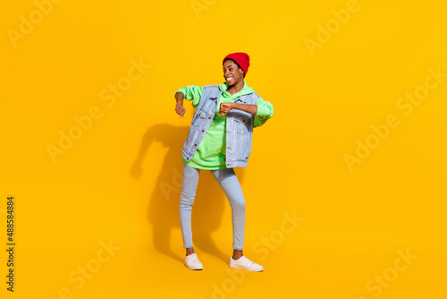 Full length body size view of attractive cheerful funky girl free time dancing isolated over bright yellow color background
