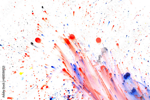 Drops of red and blue paint on a white background.