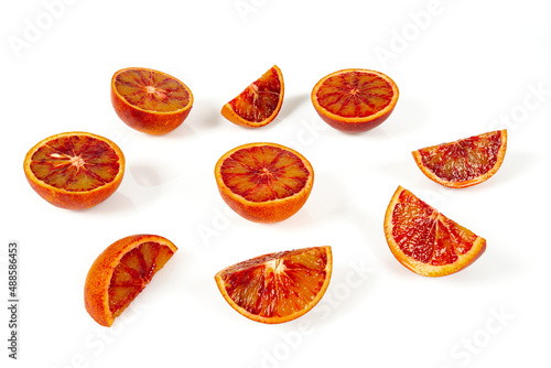 Blood oranges isolated on white background. Sliced fruit studio shots.