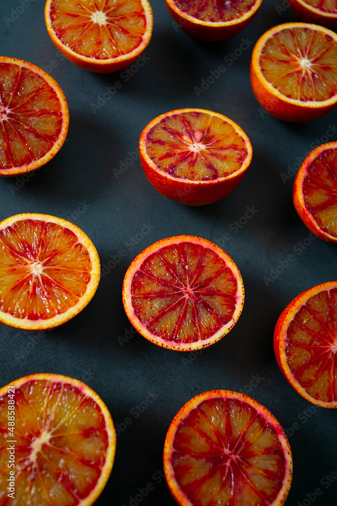 blood oranges on dark stone surface blood oranges on dark stone surface