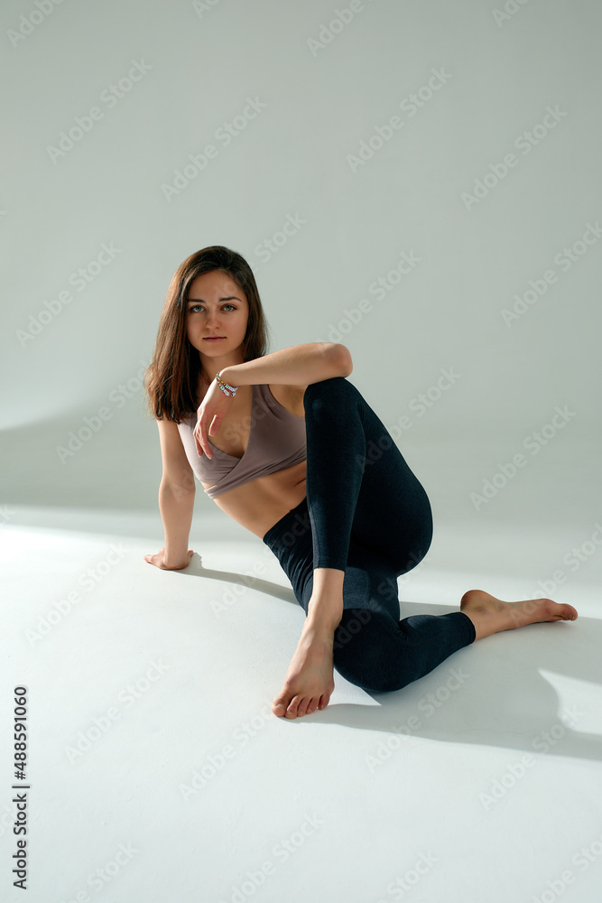 Sporty young woman doing yoga practice isolated on white background - concept of healthy life and natural balance between body and mental development. Sporty young woman doing yoga practice isolated on white background - concept of healthy life and natural balance between body and mental development.