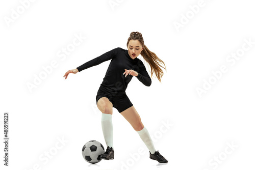 Striker. Professional female soccer, football player in action, motion isolated on white studio background. Sport, action, motion, fitness © master1305