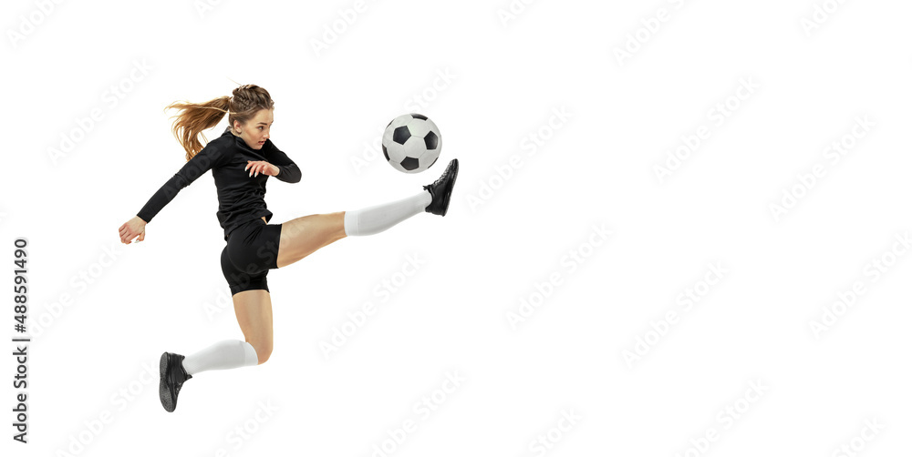 Fototapeta premium Striker. Professional female soccer, football player in action, motion isolated on white studio background. Sport, action, motion, fitness