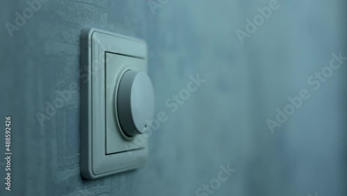 Male Hand Close-up Turns The Dimmer Switch Off The Light Switch