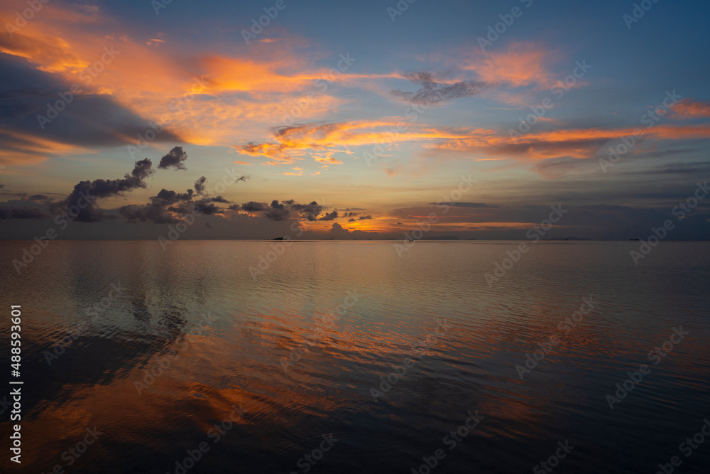 Beautiful sunset over the sea water on the island of Koh Phangan, Thailand. Travel and nature concept