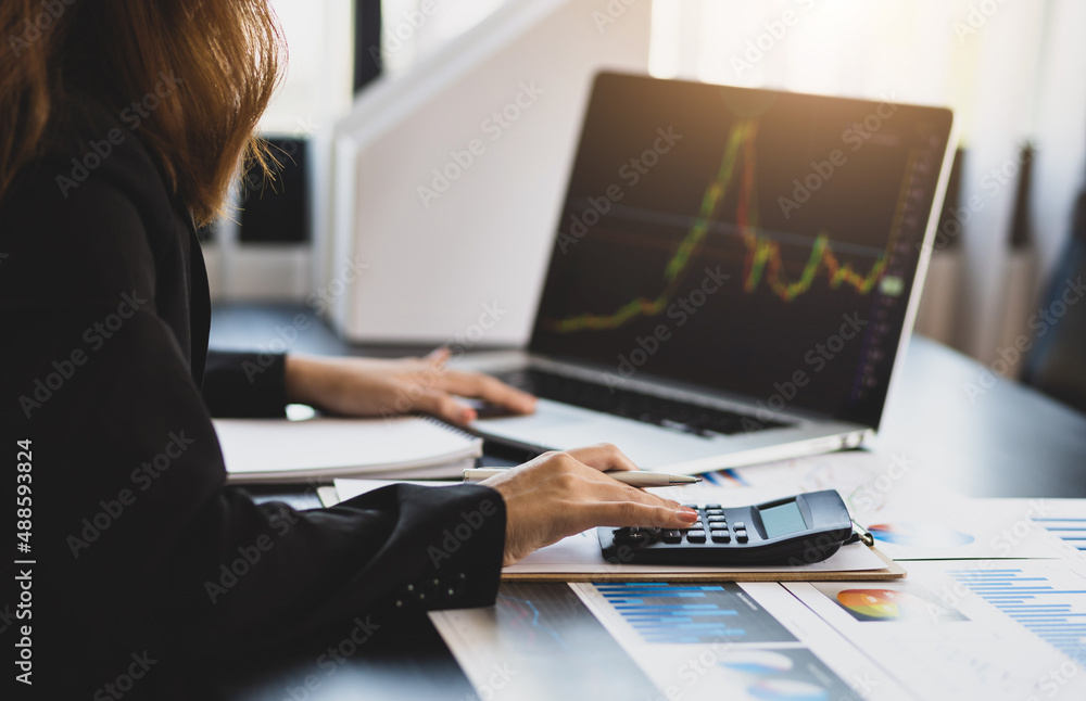 Business woman calculating analysis and investment planning with calculator and laptop. Business woman calculating analysis and investment planning with calculator and laptop.