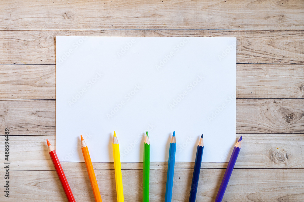 Obraz premium Colorful stationery set on the white background. Top view of blue, pink and purple notebooks, paper pins, eraser, felt tip pens, color pencils and watercolor. Back to school. Copy space.