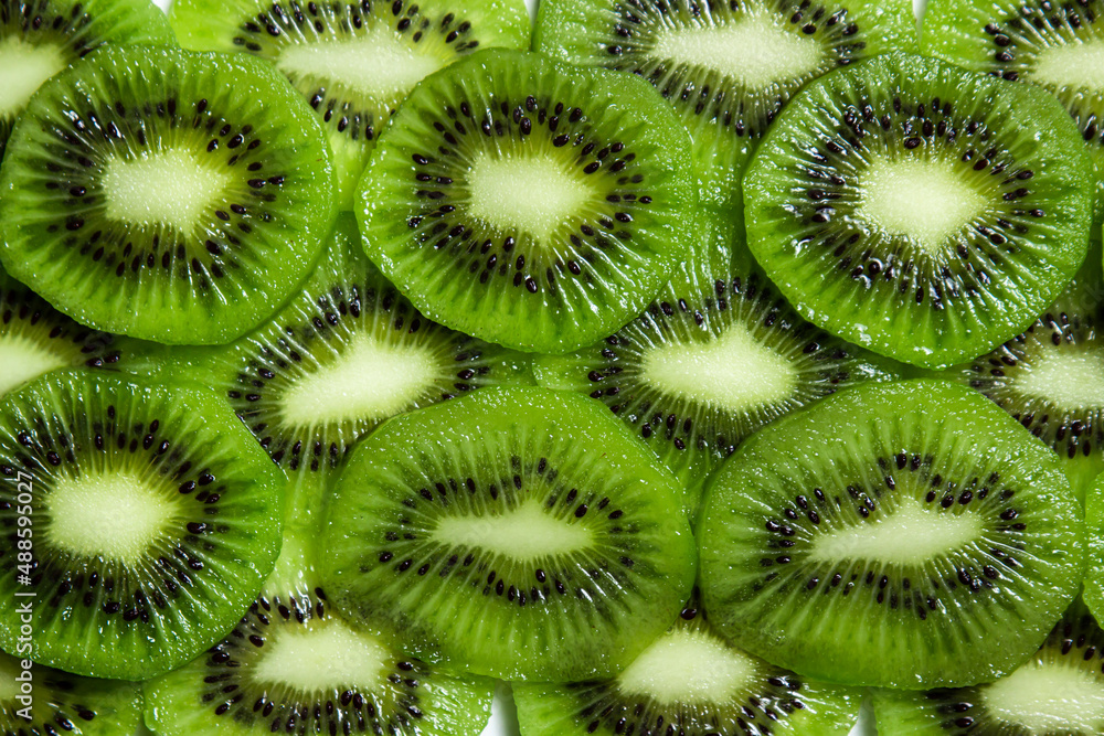 Sliced kiwi in full screen. Peeled and sliced kiwi. Kiwi texture Sliced kiwi in full screen. Peeled and sliced kiwi. Kiwi texture