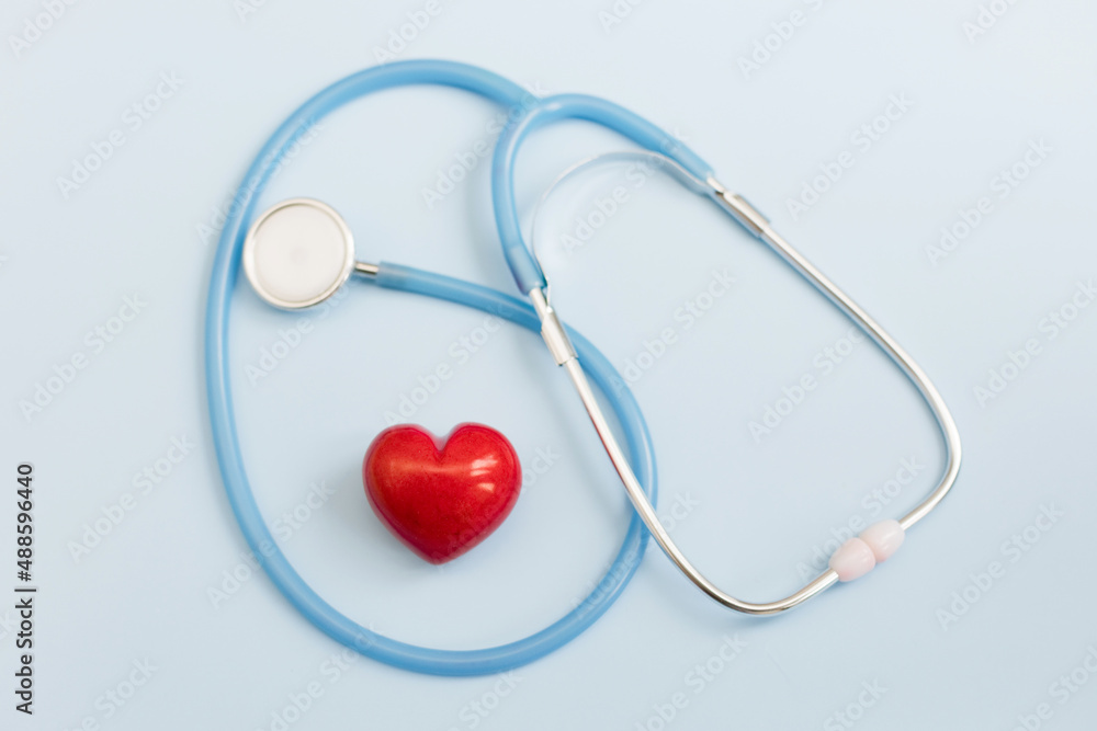 Stethoscope and red heart blue background Stethoscope and red heart blue background