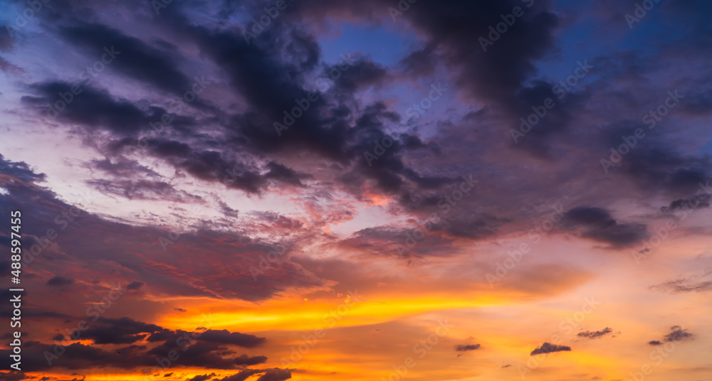 Colorful sunset sky in the evening with purple, orange sunlight clouds, dusk sky