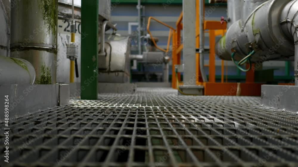 Built inside a steel structure oil and chemical refinery consisting of pipes, valves, controls devise and machine. Panning video Built inside a steel structure oil and chemical refinery consisting of pipes, valves, controls devise and machine. Panning video